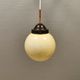 Small Art Deco hanging lamp in cream coloured glass and bakelite top.