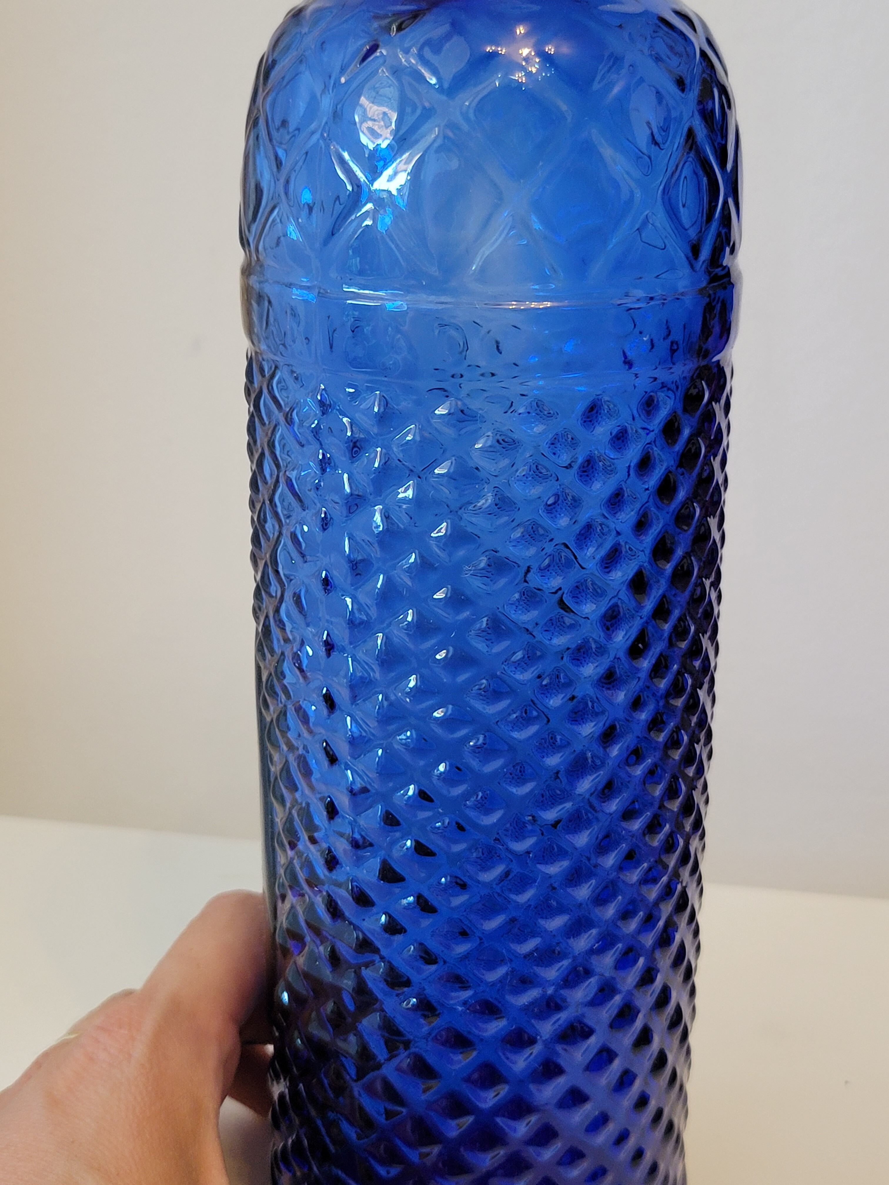 Vintage decanter bottle made of blue molded pressed glass