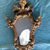 Antique scalloped mirror with pediment decorated with cherubs – carved gilded wood