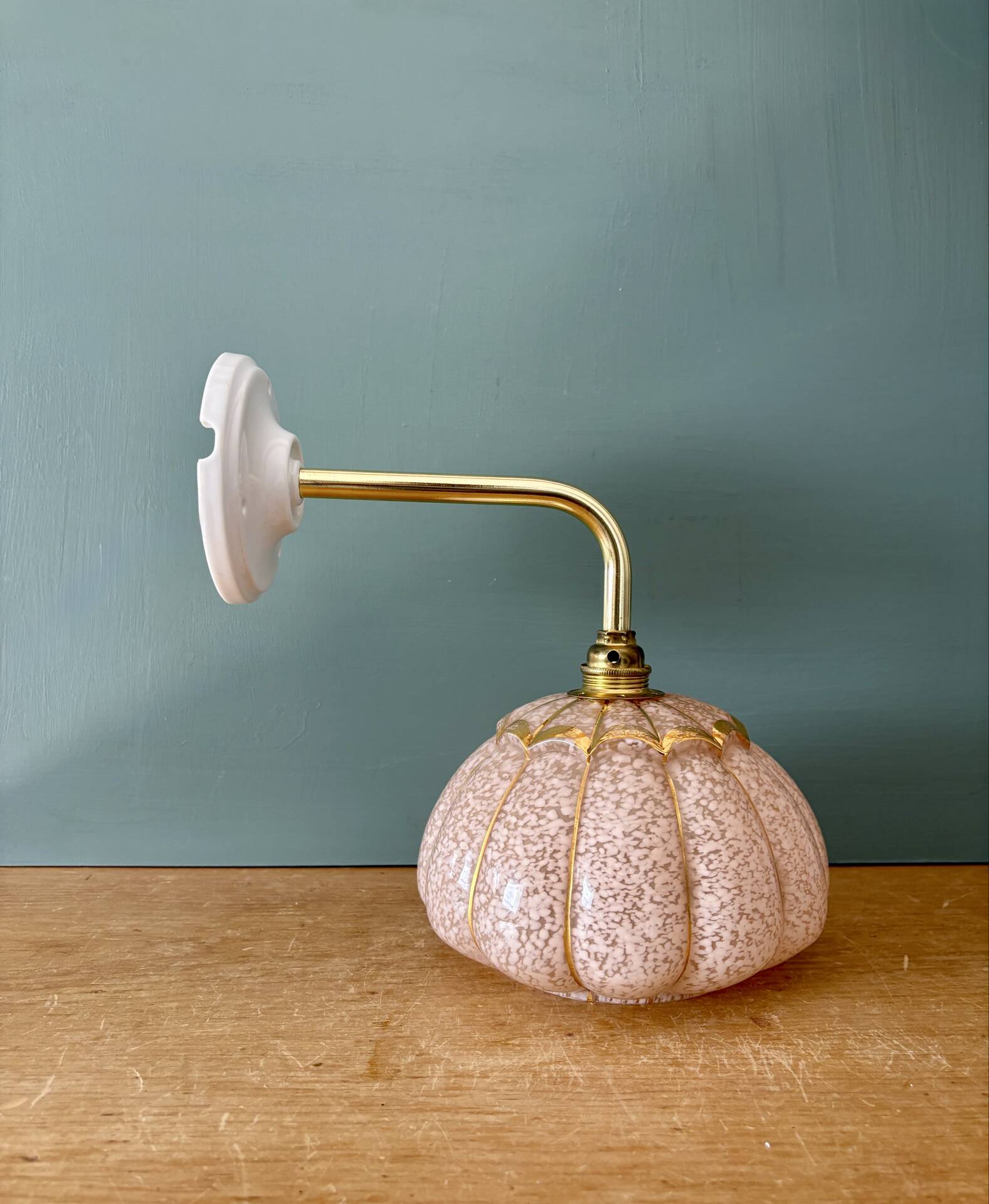 Vintage glass wall light with a pink and gold Clichy globe.