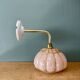 Vintage glass wall light with a pink and gold Clichy globe.