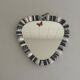Small wall mirror, round triangle in black and white ceramic, 1950s, Germany.