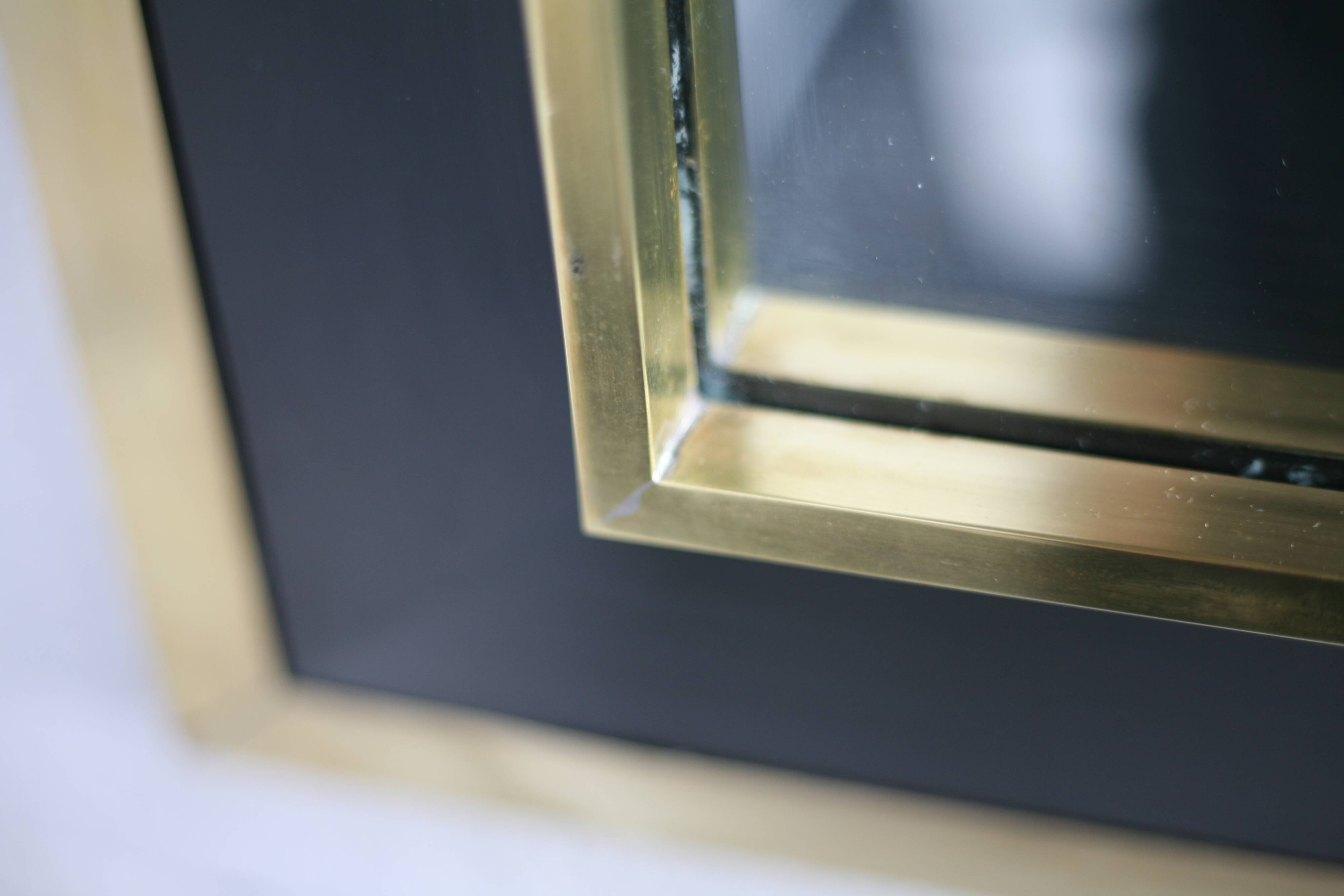 Jean-Claude Mahey mirror. Black lacquered wood and gold metal. 1970