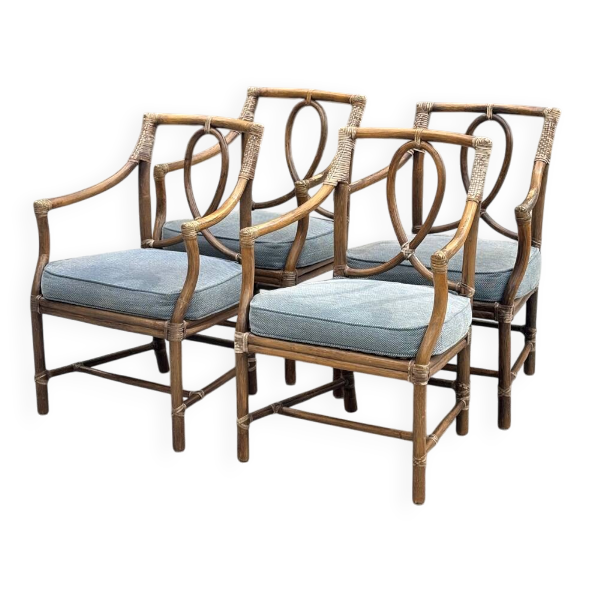 Set of 4 vintage McGuire rattan chairs with cushions.