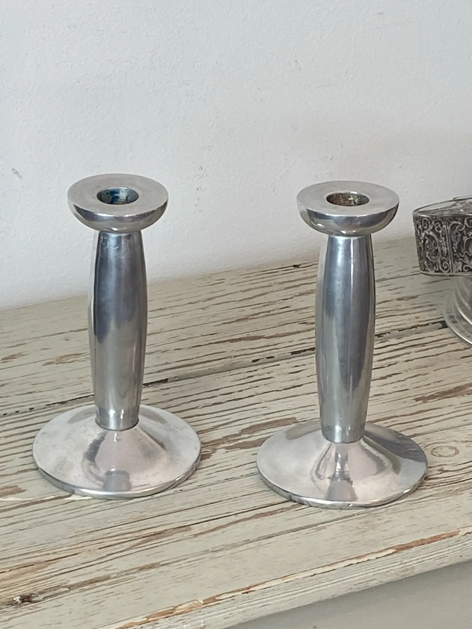 Pair of minimalist polished aluminium candle holders
