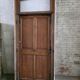 Old solid oak front door with frame and transom from the 19th century.