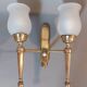 Neoclassical Torch two-arm wall lamp in solid brass, circa 1940