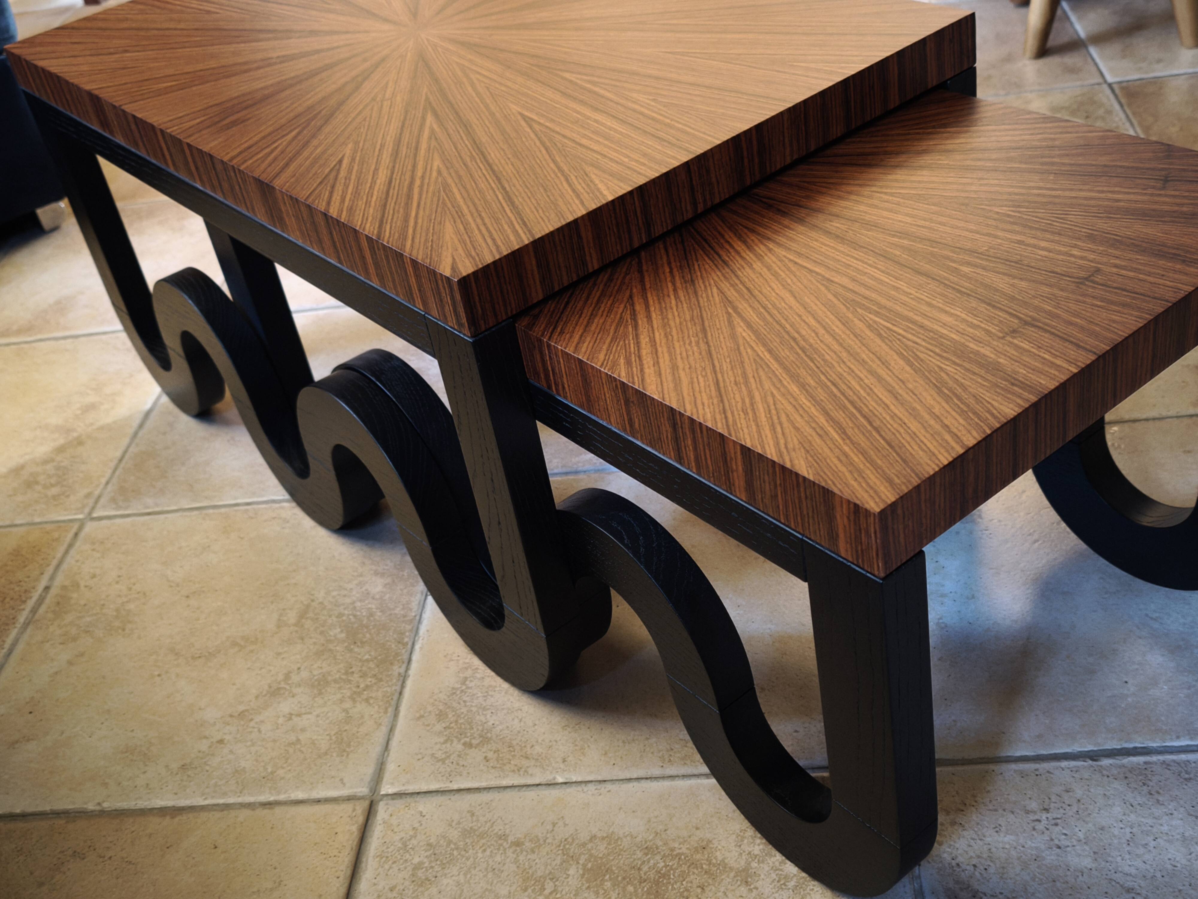 Nest of coffee tables in lacquer and rosewood veneer.