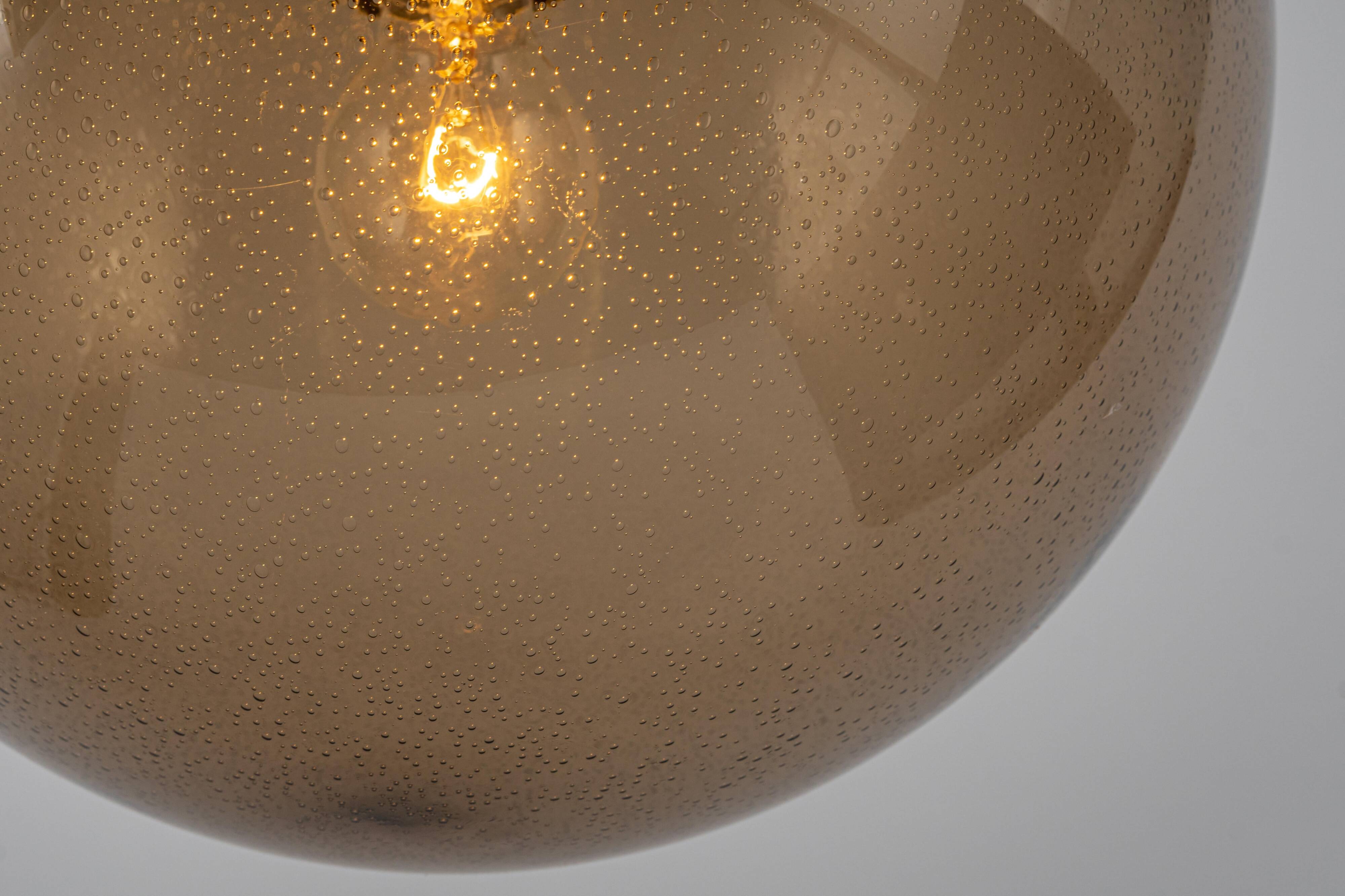 Large smoked glass ball pendant by Limburg with brass, Germany, 1970s.