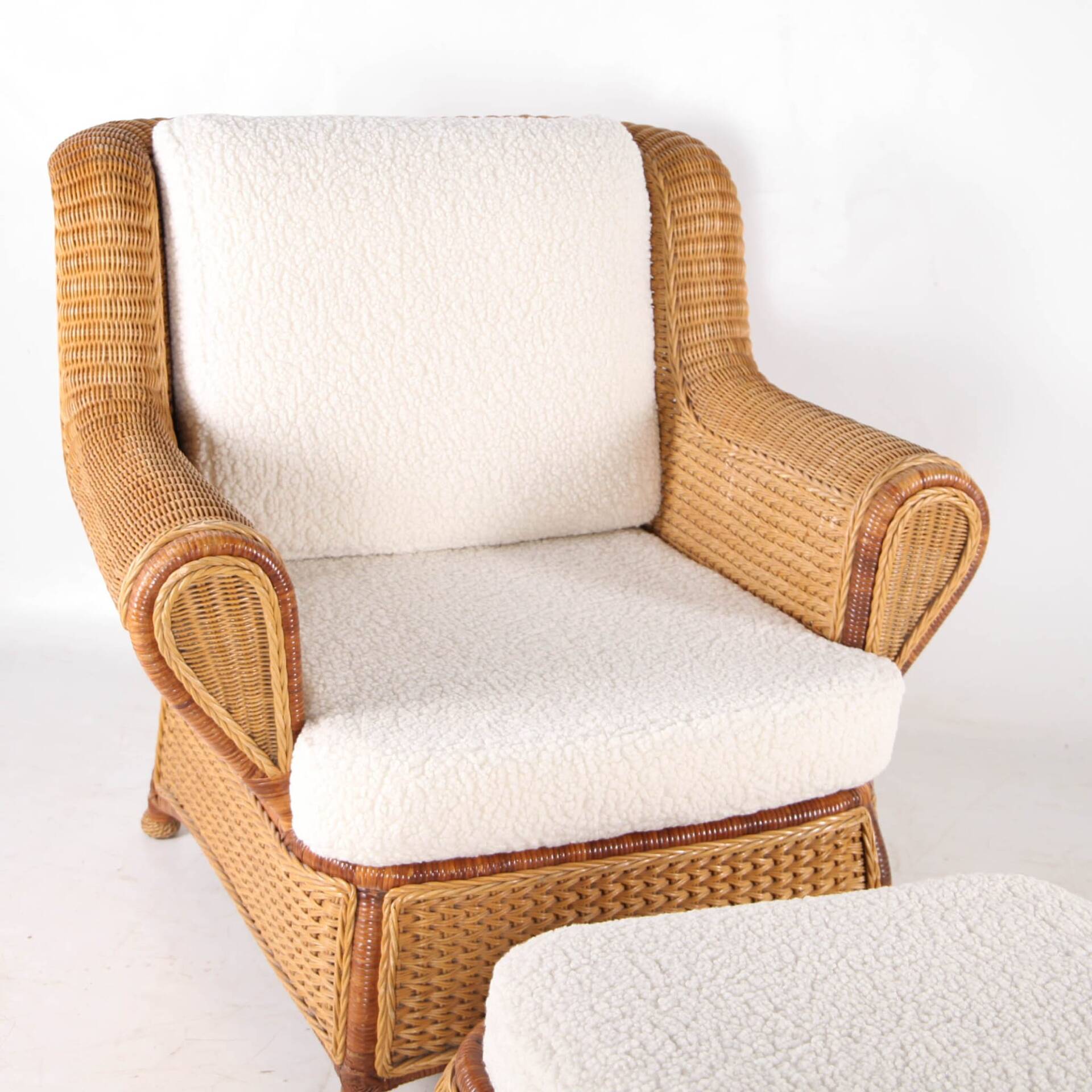 Large wicker armchair and its ottoman