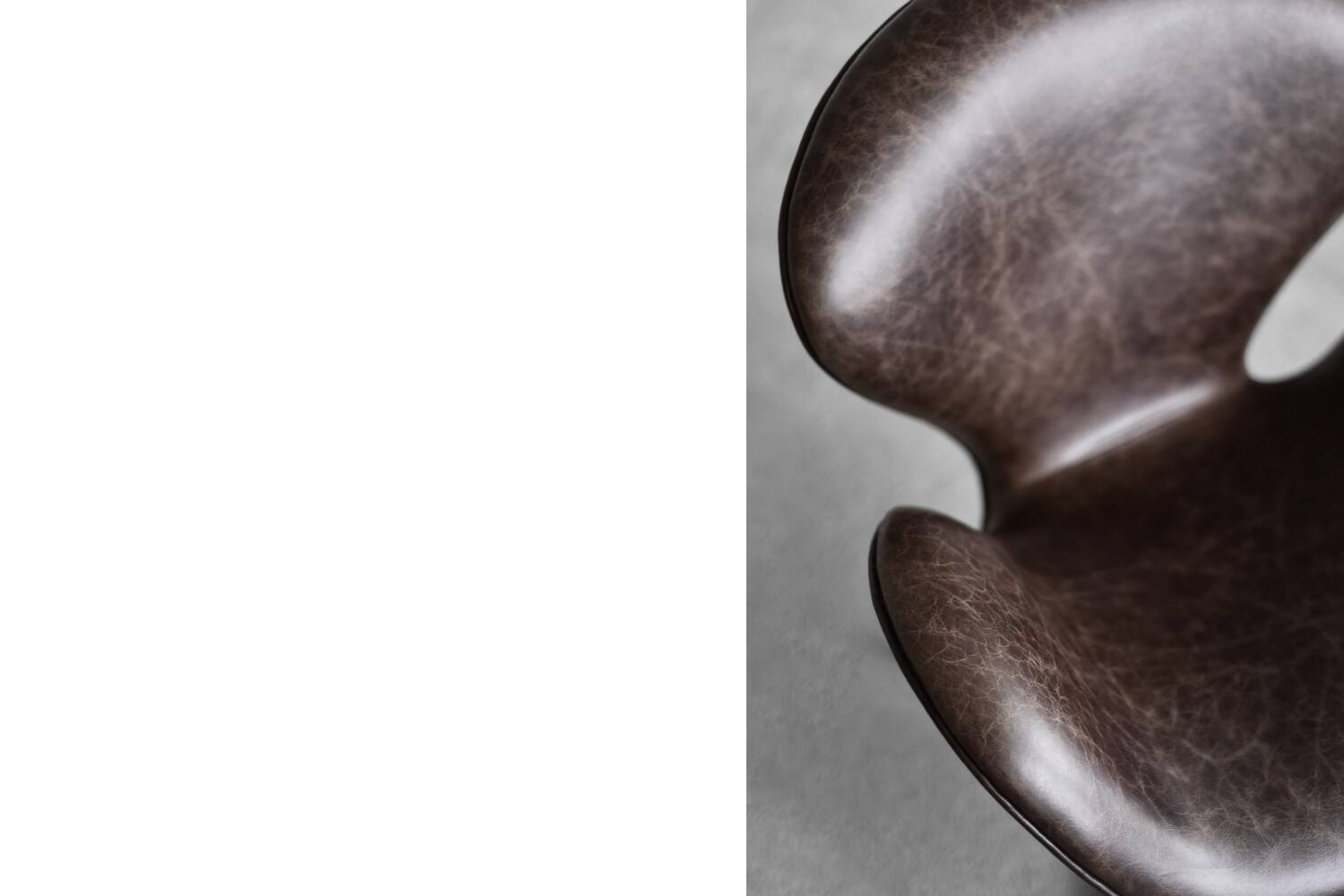 Brown leather Swan chair by Arne Jacobsen, mid-century Danish modernity.
