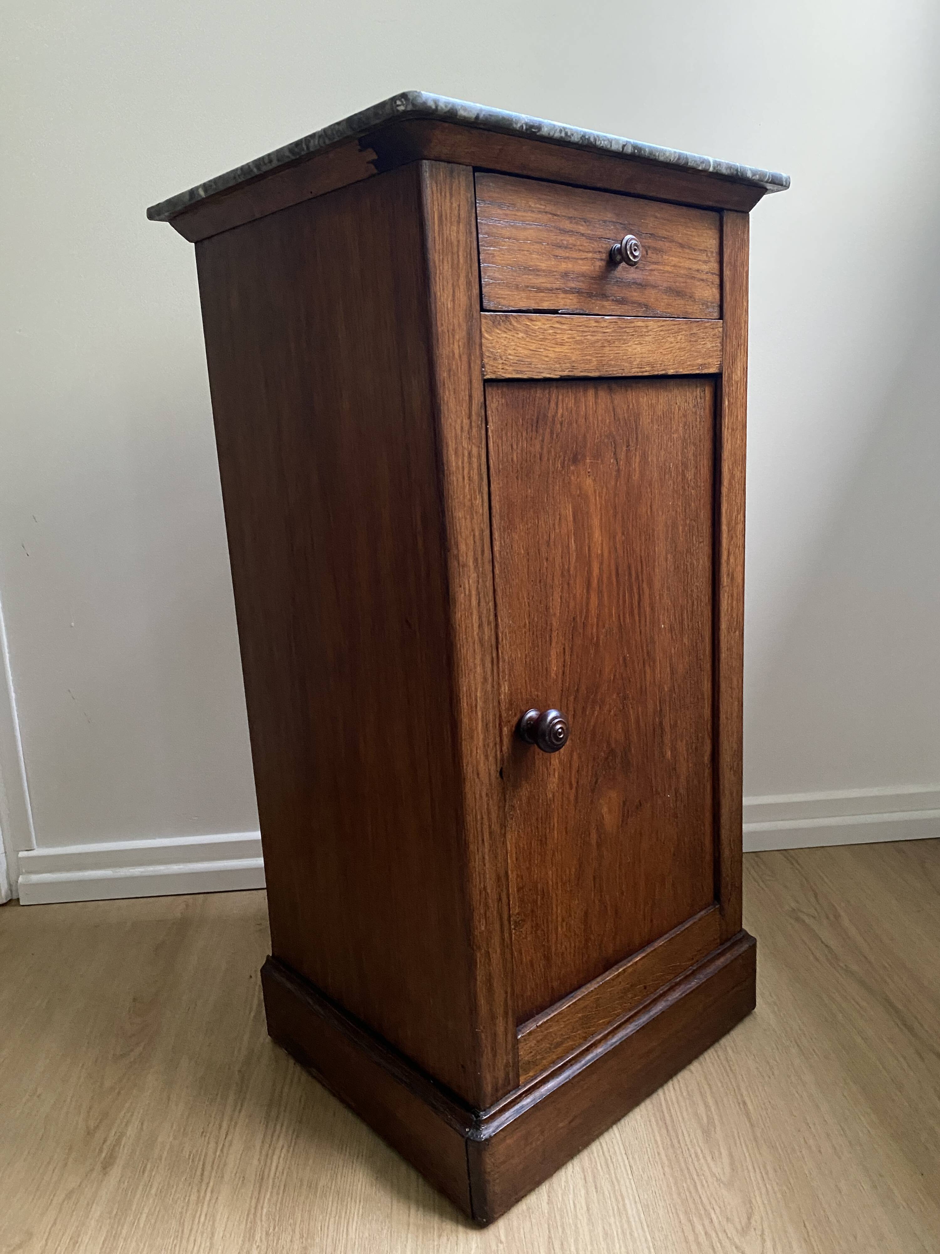 Vintage bedside table in the shape of a wooden column and a gray marble top