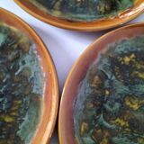 Set of 4 flamed enamel plates in green and amber from the 60s-70s.