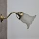Brass gooseneck wall lamp and tulip lampshade
