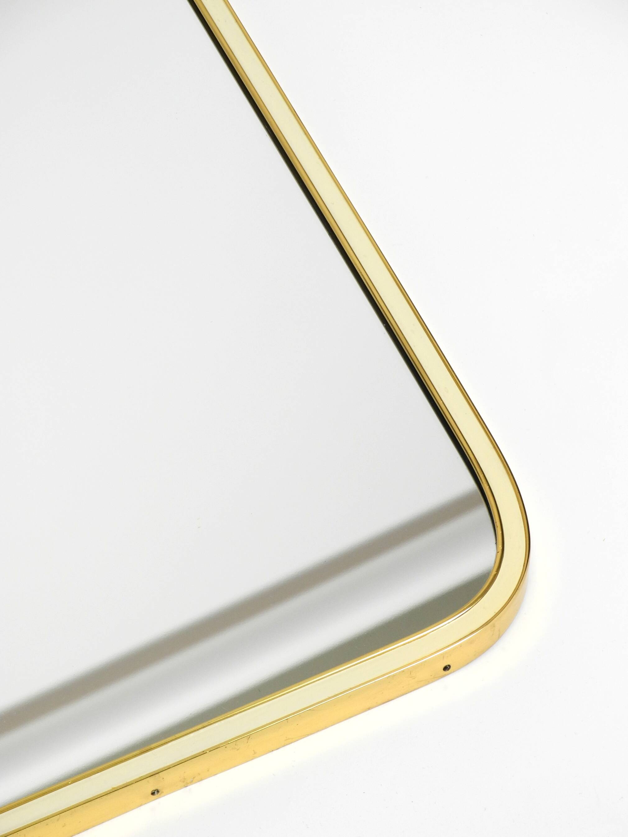 Large heavy long Mid Century brass wall mirror by Münchner Zierspiegel