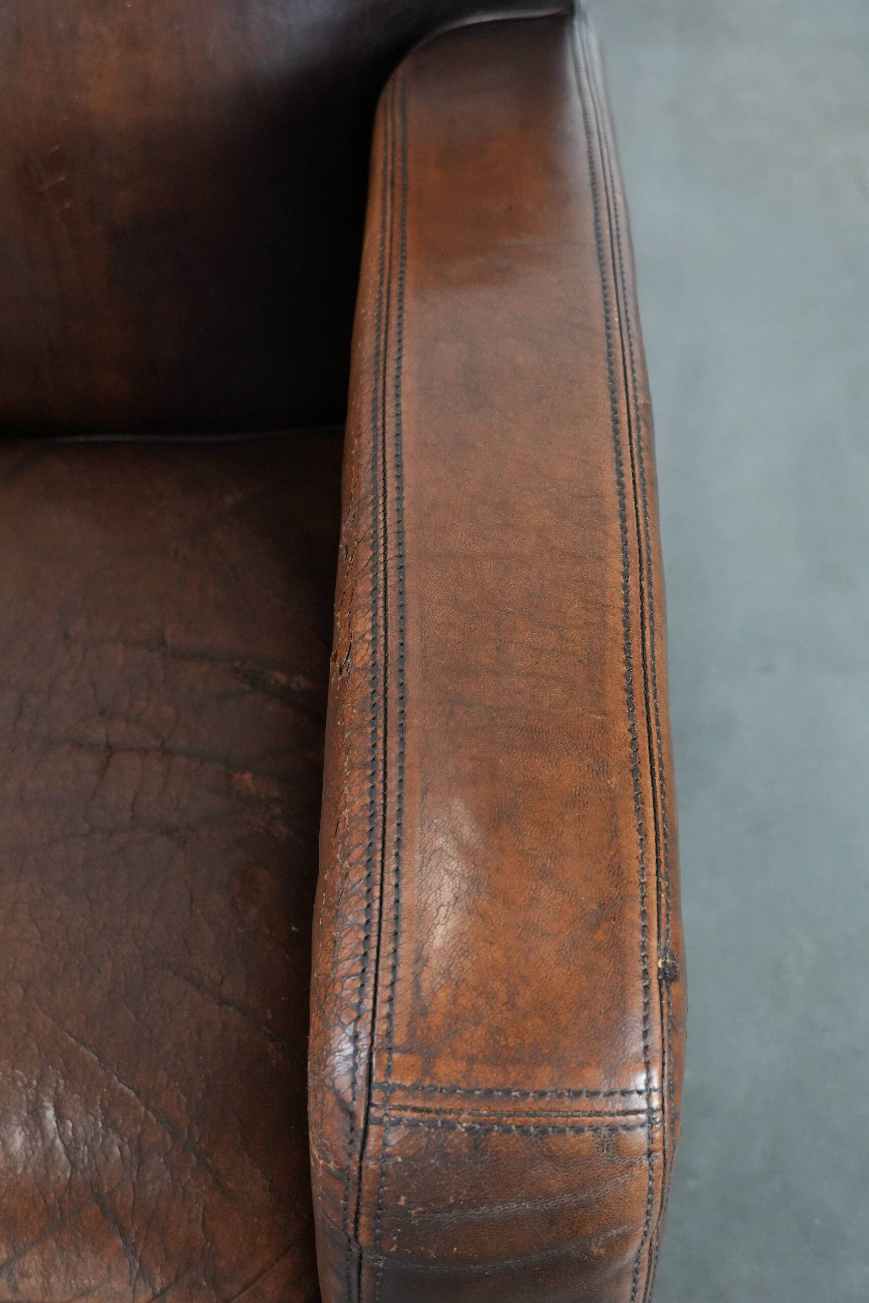 Beautifully shaped vintage sheepskin armchair with character