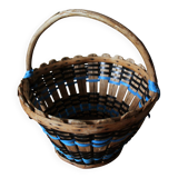 Vintage wooden basket with round handle, blue and black weaving.