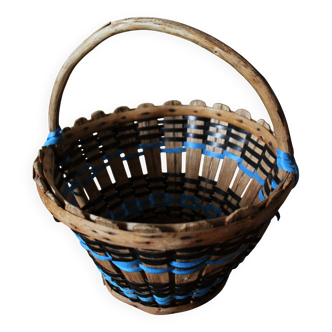 Vintage wooden basket with round handle, blue and black weaving.