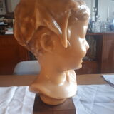 Child's head in wax on wooden base