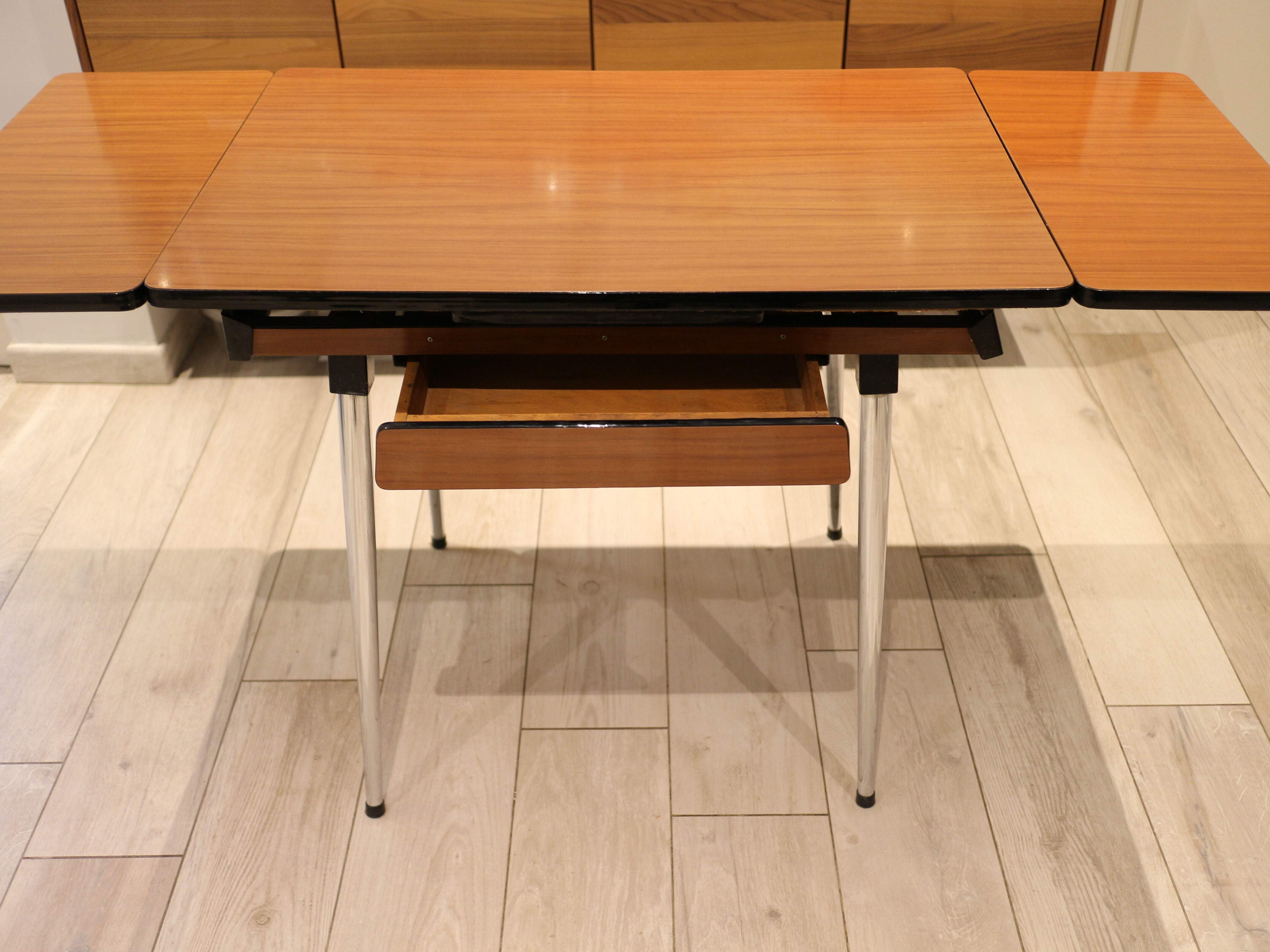 Briwn Formica table with extension cords and drawer