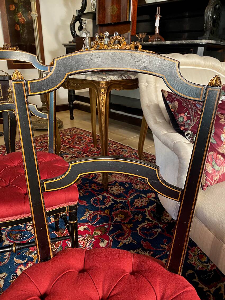 Set of four Napoleon III chairs in black lacquered wood with gold highlights.