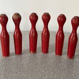 Set of old wooden bowling pins in red