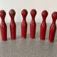 Set of old wooden bowling pins in red