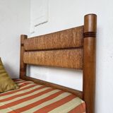 Brutalist style bed with chain and straw