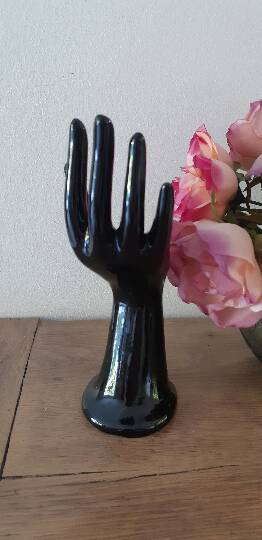 Hand holds black jewelry, ring sizer, soliflore, vintage French, 50s