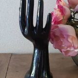 Hand holds black jewelry, ring sizer, soliflore, vintage French, 50s