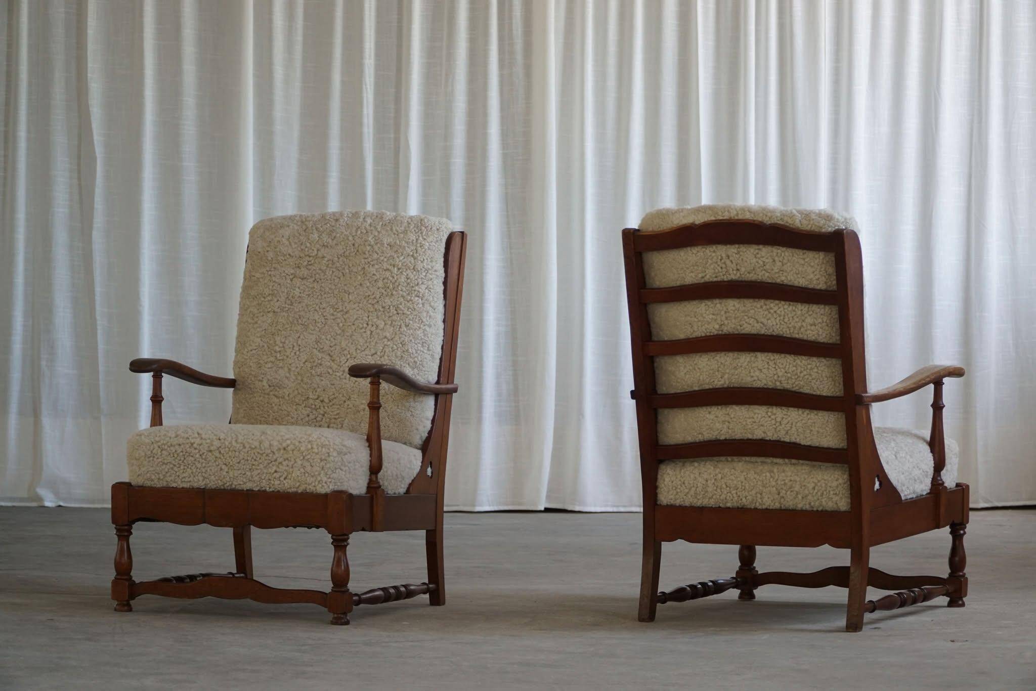 Modern Danish design, a pair of high-backed armchairs in oak and lambswool, 1950s.