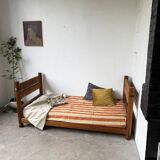Brutalist style bed with chain and straw