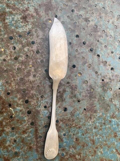 Lot of mismatched silver metal serving cutlery, a ladle and a fish knife