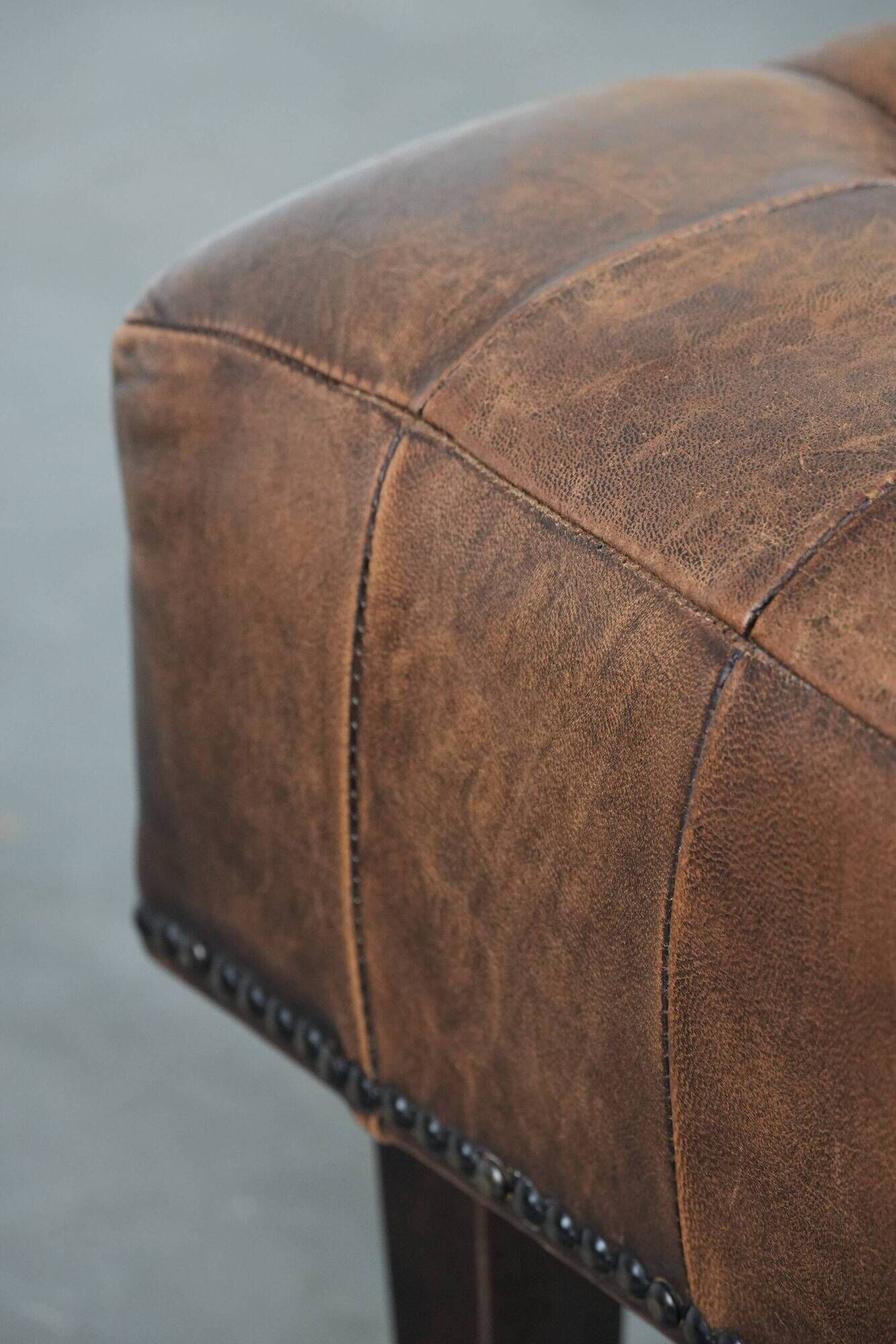 Beautiful sheepskin ottoman on high legs and beautiful warm colours