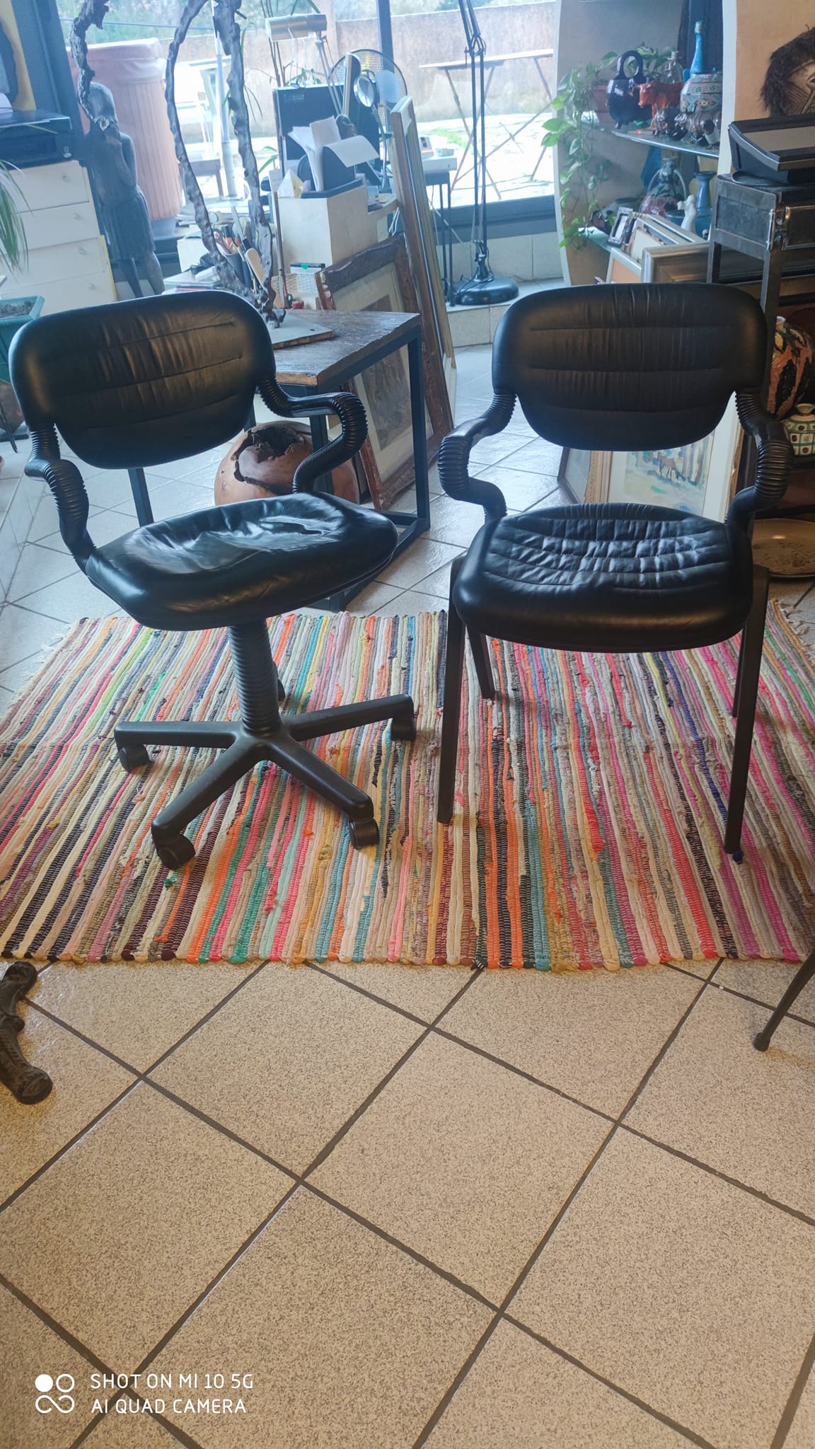 Two black leather armchairs