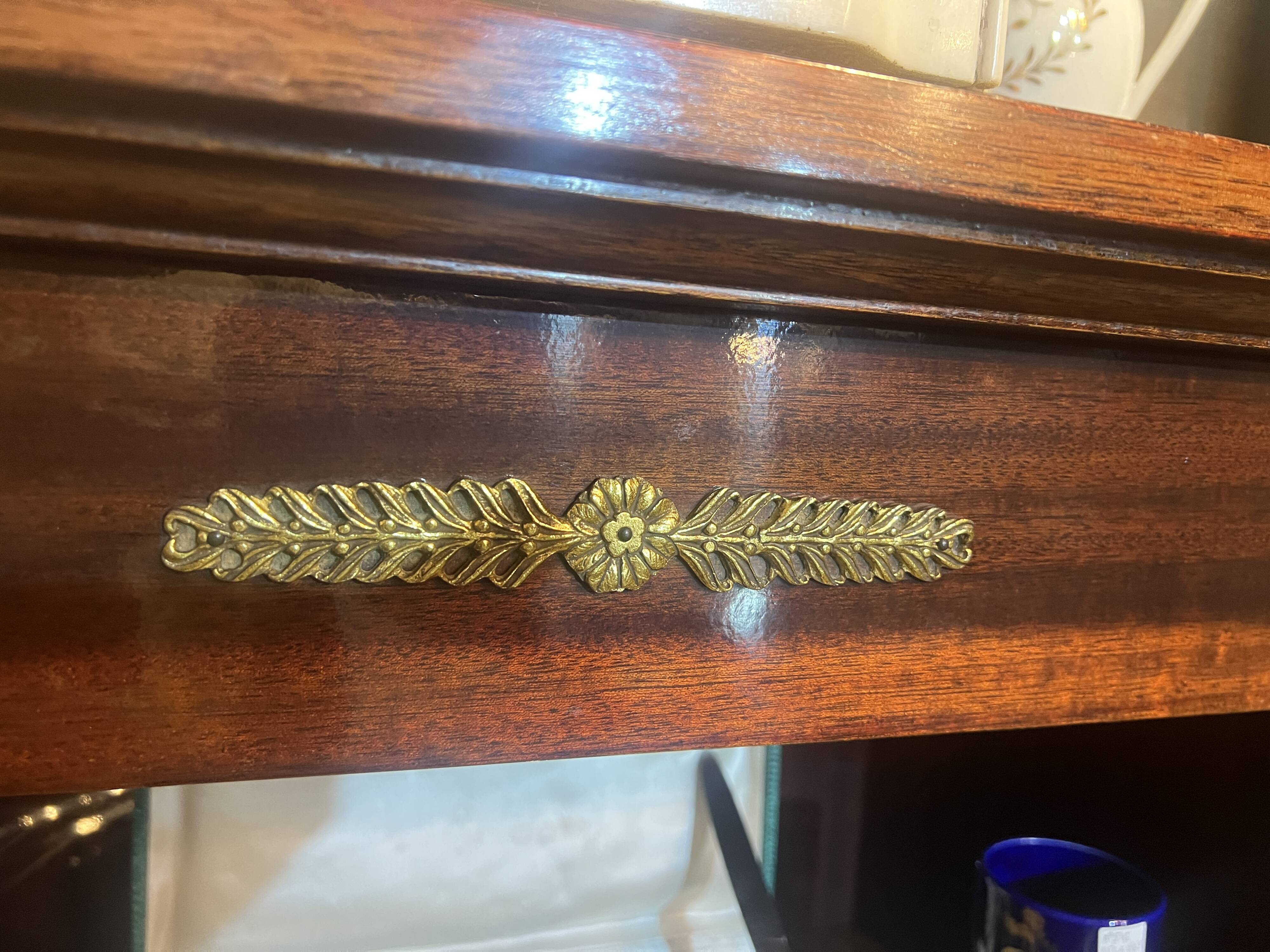 Directoire style bookcase in mahogany, decorated with gilded bronze.