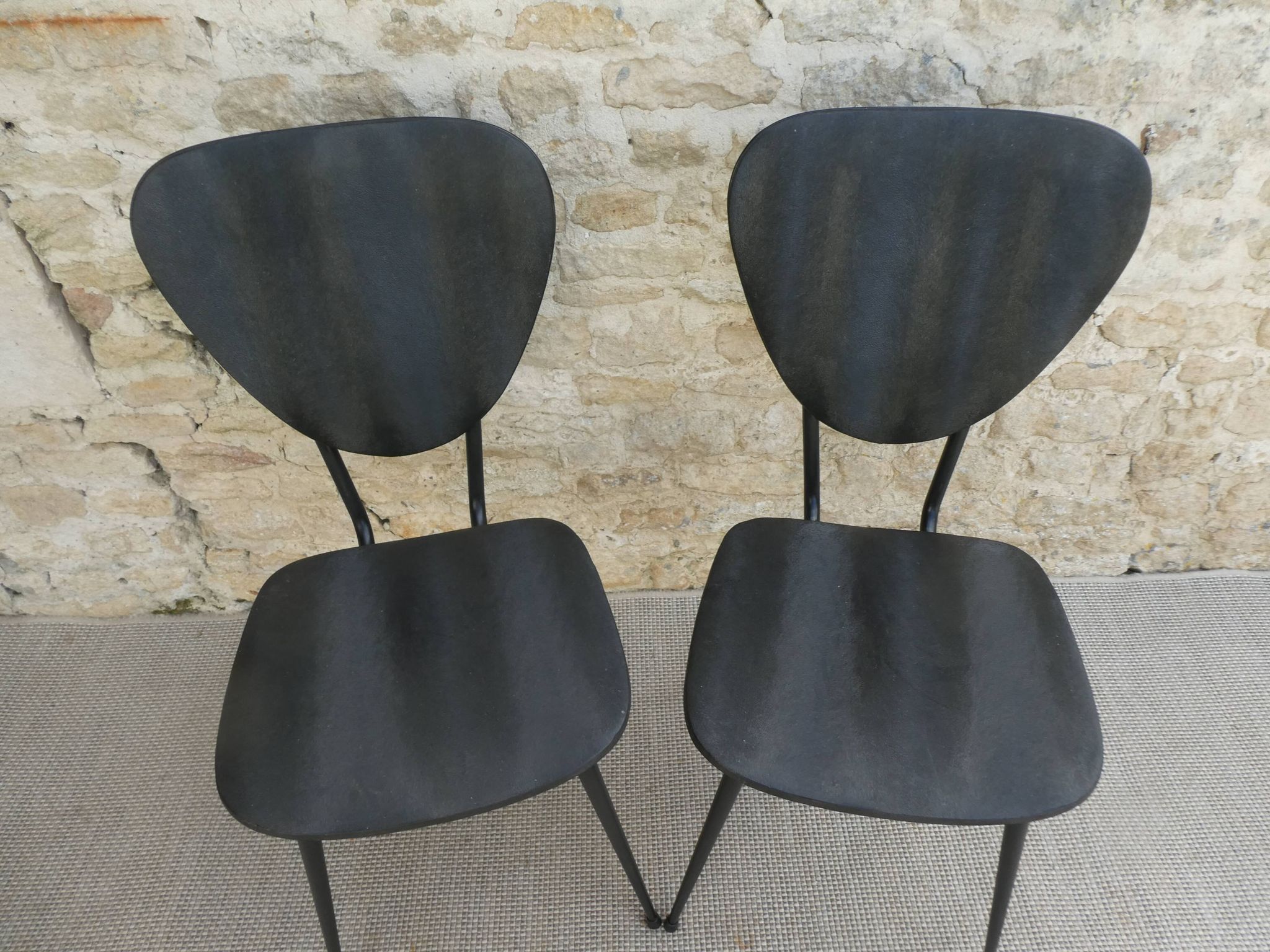 Pair of chairs with tapered metal legs and black Skaï, 60s