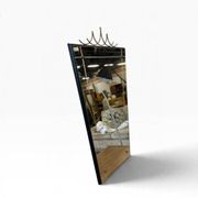Elegant black wall mirror in vintage style with brass accents.