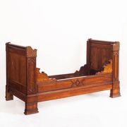 Bed made of solid walnut with marquetry details. France, 1930s.
