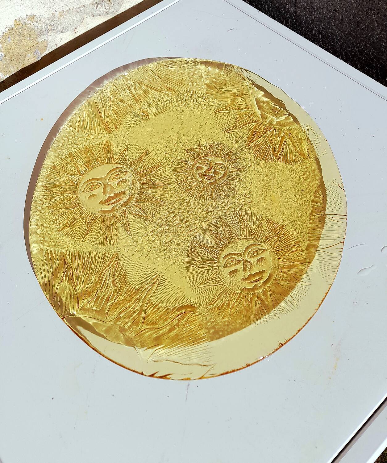 Glass plate decorated with suns, 1980.