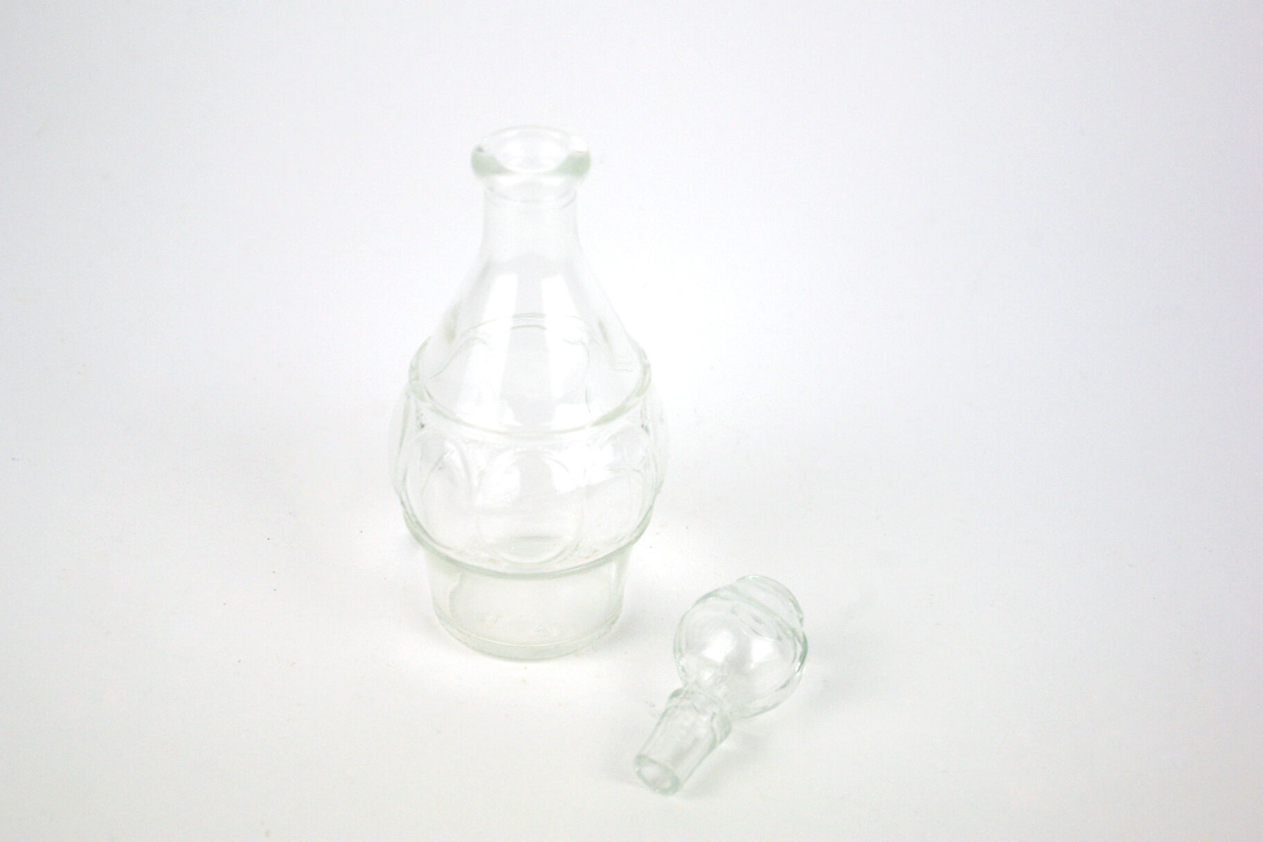 Small bottle with a glass cap with geometric patterns