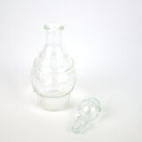 Small bottle with a glass cap with geometric patterns