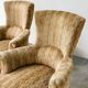 Pair of sculptural Hollywood Regency lounge chairs with original fringed upholstery