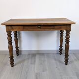 Antique writing table in the Napoleon III style with turned wooden legs.
