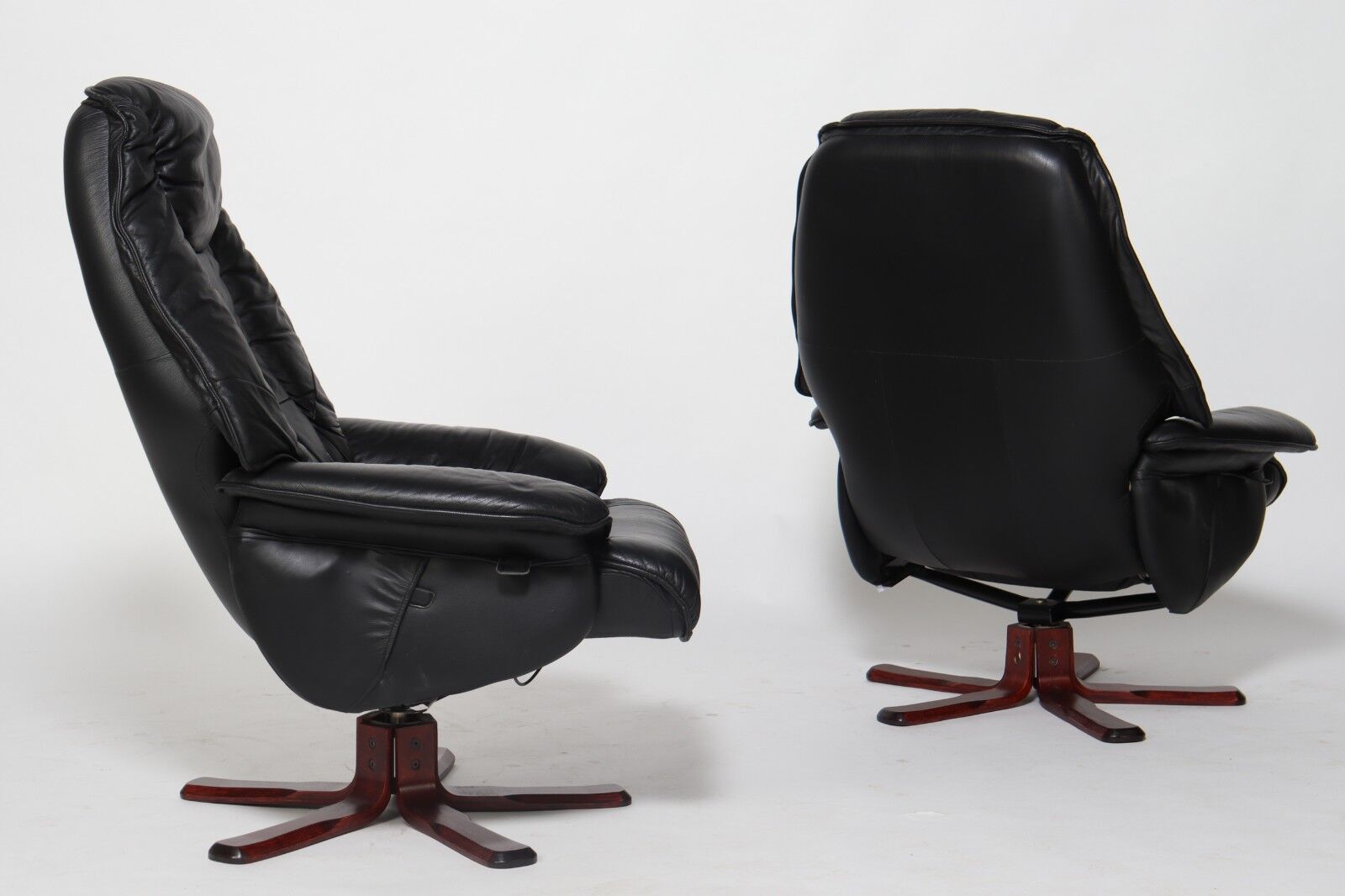 Pair of Danish black leather recliner swivel chairs by Hjort Knudsen