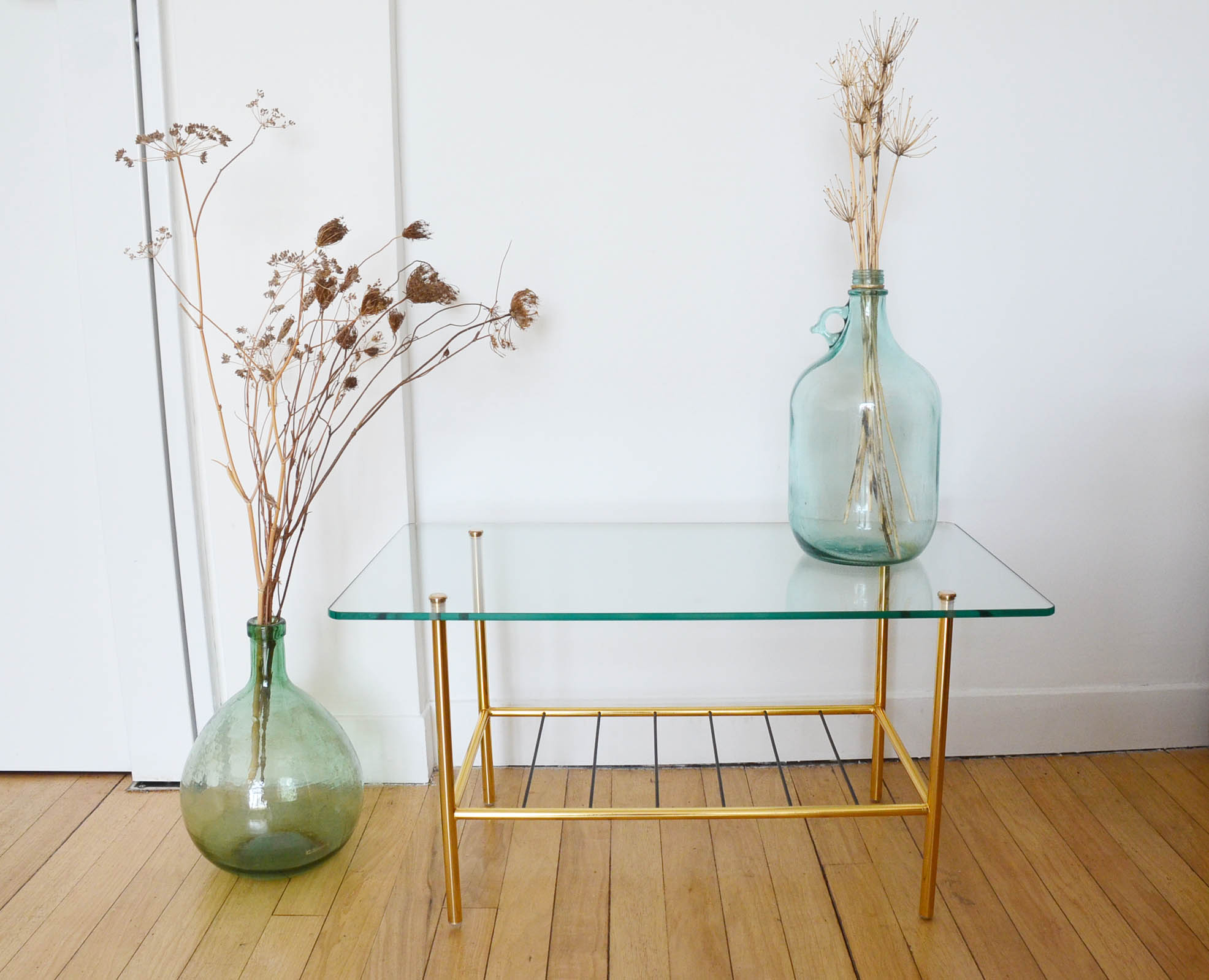 Glass coffee table with magazines holder