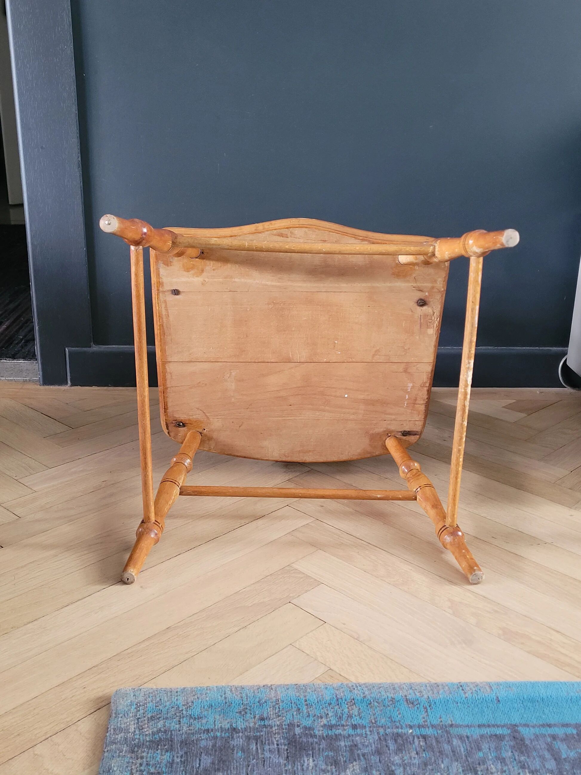 Antique wooden child's armchair from the early 20th century.