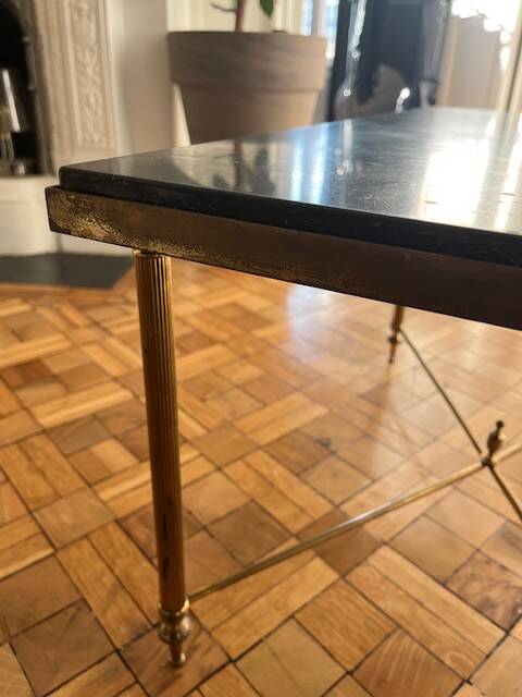 Black marble coffee table with brass legs.