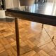 Black marble coffee table with brass legs.