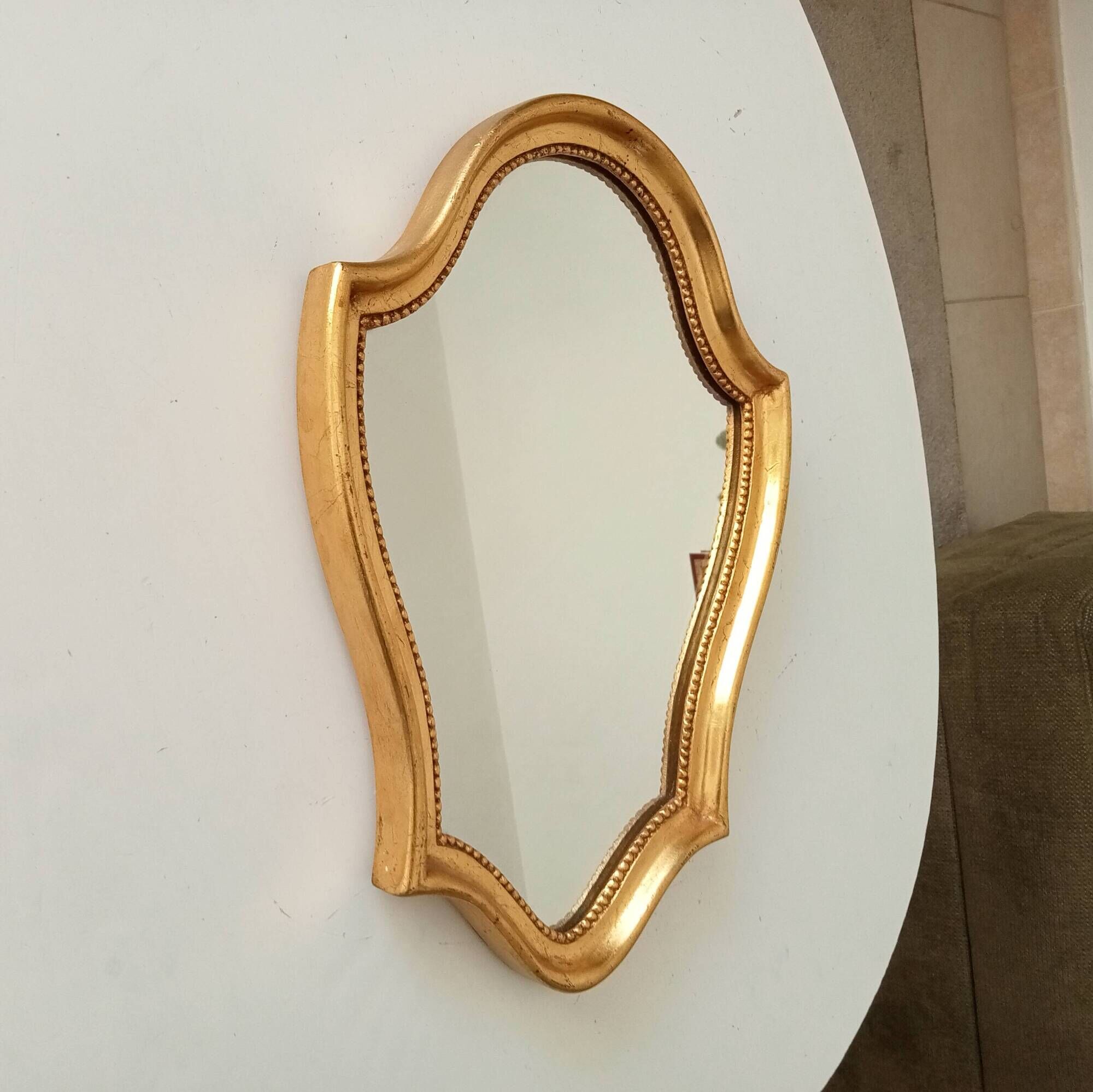 Vintage baroque mirror in gilded wood in the Louis XV style.